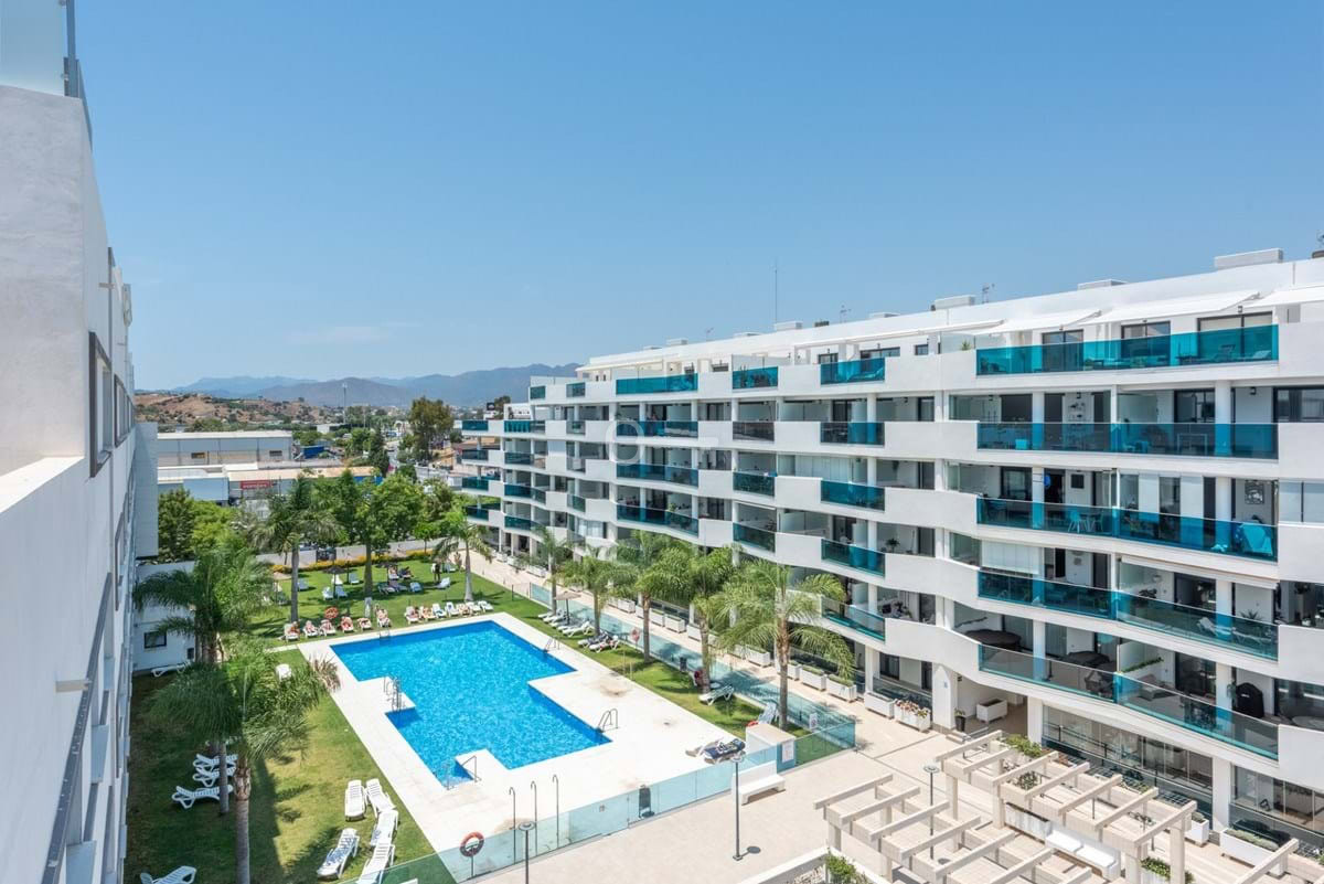 Nowoczesny kompleks mieszkaniowy z basenem i panoramicznymi balkonami, idealny dla inwestycji w nieruchomości.