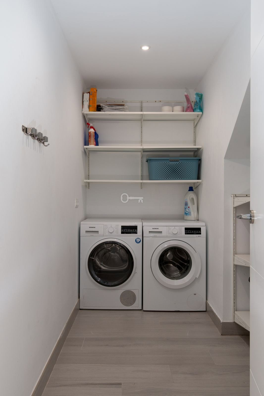 Pralka i suszarka w pralni, praktyczne urządzenia do prania i suszenia odzieży, nowoczesny sprzęt AGD w domu.